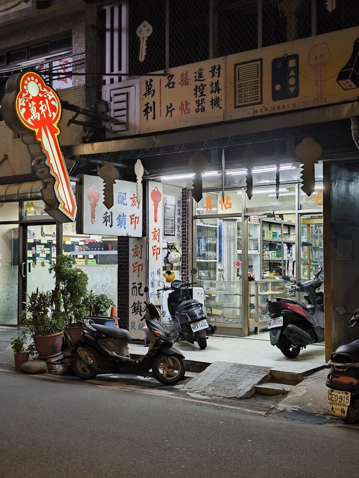 Illuminated Kiosk by Night and Motorbikes